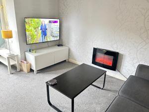 ペイズリーにあるPaisley Central Apartment #3のリビングルーム(テレビ、暖炉付)