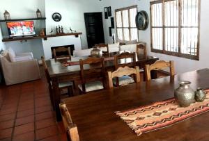 a living room with a table and a dining room at Posada La Celia in Eugenio Bustos