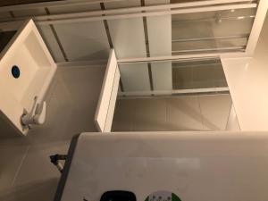 a white cabinet with a glass door in a kitchen at Studio with terrace in Saint-Denis