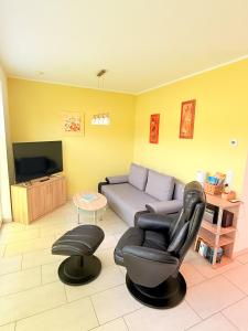 a living room with a couch and a chair at Natur und Meer in Graal-Müritz