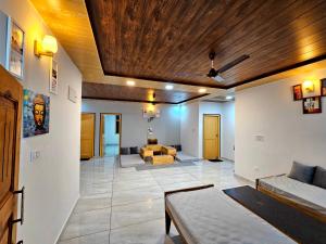 a living room with a couch and a table at Mysuru Villa in Bīr