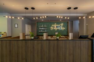 a restaurant with a bar with a chalkboard on the wall at Altstadt Hotel Hofwirt Salzburg in Salzburg +44 photos