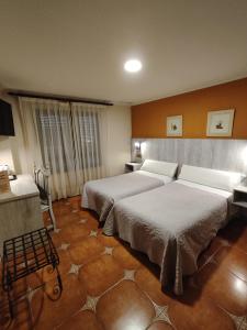 Postel nebo postele na pokoji v ubytování Hostal La Posada