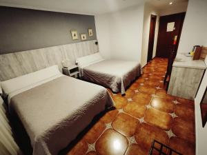 Postel nebo postele na pokoji v ubytování Hostal La Posada