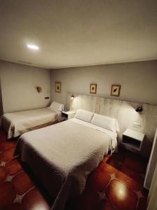 Postel nebo postele na pokoji v ubytování Hostal La Posada