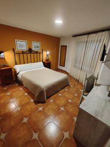 Postel nebo postele na pokoji v ubytování Hostal La Posada