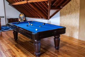 a pool table with balls on it in a room at Fun and Fly House in Praia da Vitória