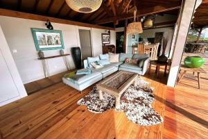 a living room with a couch and a coffee table at Villa Acoma Lodge in Grand-Bourg