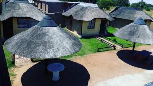 an aerial view of a house with umbrellas at Jamrock Lodge in Winterveld