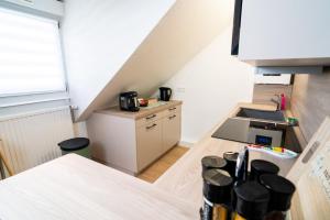 a small kitchen with a sink and a stove at Le Cosy du Brasseur - Magnifique Duplex Schiltigheim, Proche Strasbourg in Schiltigheim