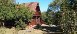 a small wooden building with a balcony on it at alpinas lapaloma in La Paloma