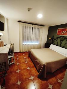 Postel nebo postele na pokoji v ubytování Hostal La Posada