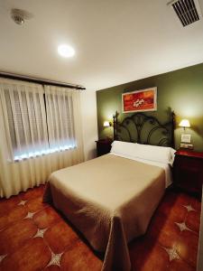 Postel nebo postele na pokoji v ubytování Hostal La Posada