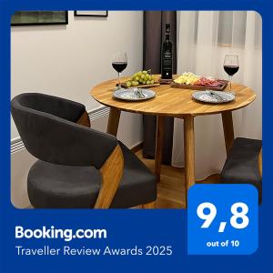 a table with two chairs and two glasses of wine at Jahorina Apartment4Two in Jahorina