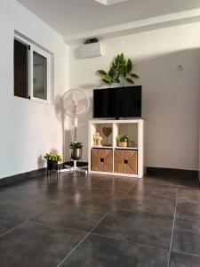 a living room with a flat screen tv on a wall at Sun Beach Arinaga in Arinaga