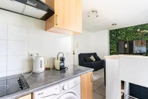 a kitchen with a stove top oven next to a counter top at Geneva Green Studio in Gaillard
