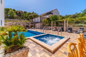 a swimming pool in the middle of a yard at La Perla Apartments 2 in Sutivan