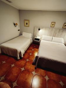 Postel nebo postele na pokoji v ubytování Hostal La Posada
