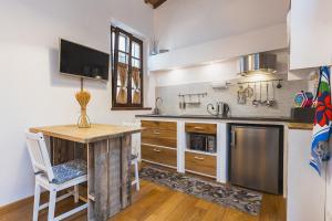 a kitchen with a wooden table and a counter top at Sofia a Montepulciano in Montepulciano