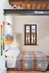 a bedroom with a bed and a window at Sofia a Montepulciano in Montepulciano