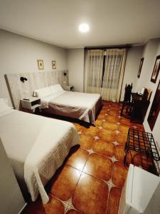 Postel nebo postele na pokoji v ubytování Hostal La Posada