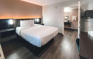 a hotel room with a large bed and a bathroom at Studio 6 West Sacramento CA in West Sacramento +18 photos