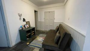 a living room with a couch and a table at Casa Jabuticabeira in Ouro Preto