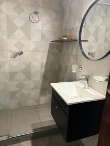 a bathroom with a sink and a mirror at Paraíso Costero San Bernardo in San Bernardo