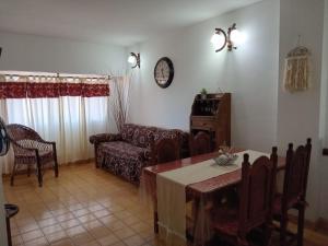 a living room with a table and a couch at Paraíso Costero San Bernardo in San Bernardo +3 photos