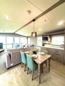 a living room with a table and a couch at Skye View Lodge in Filey