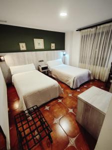 Postel nebo postele na pokoji v ubytování Hostal La Posada