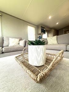 a living room with a couch and a table at Skye View Lodge in Filey