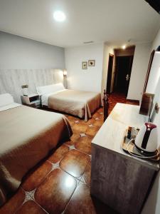 Postel nebo postele na pokoji v ubytování Hostal La Posada