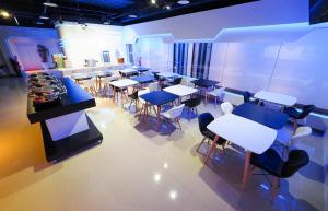 a room with tables and chairs in a room at Galaxia Business Hotel in Taichung