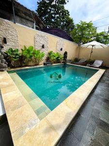 a swimming pool in front of a house at Villa Kinandari 2 Candidasa in Candidasa