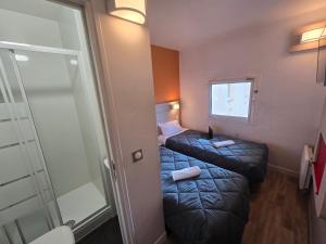 Postel nebo postele na pokoji v ubytování Premiere Classe Valence - Bourg Les Valence