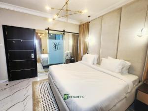 a bedroom with a large white bed in a room at Ihsuites in Asaba