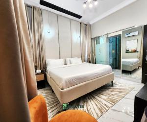 a hotel room with a bed and a mirror at Ihsuites in Asaba