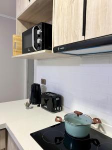 a pot on a stove top in a kitchen at Departamento Boldo in Puerto Montt +5 photos