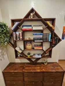 a wooden book shelf with books on it at Private SPA Apartment in Rome in Rome