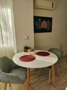 a table with two rugs on it in a room at ALDIRA Studio Arena Nationala in Bucharest