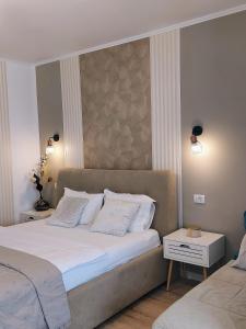 a bedroom with a large bed with white pillows at ALDIRA Studio Arena Nationala in Bucharest