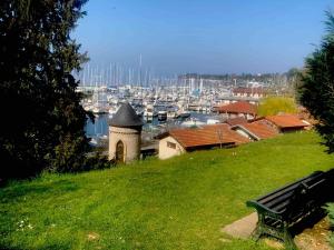 a park bench sitting on a hill overlooking a harbor at T1 bis à deux pas du Belvédère in Thonon-les-Bains