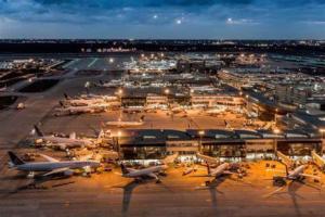 an airport with several airplanes parked at night at Studio 6 Conroe, TX in Conroe