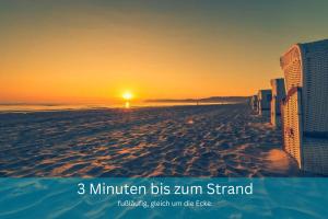 a picture of a beach with the sun setting at Küstentraum Strandmuschel - 1 Raum Appartement in Binz