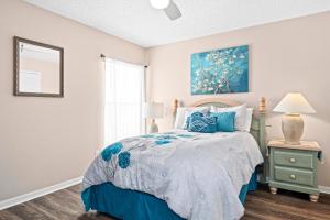 a bedroom with a bed with a blue comforter at Family Villa Destination in Davenport +32 photos