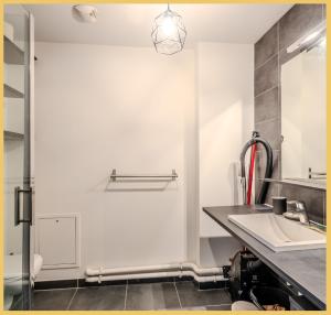 a white bathroom with a sink and a mirror at Chez Mike I Studio I Annemasse in Annemasse