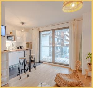 a kitchen and living room with a large window at Chez Mike I Studio I Annemasse in Annemasse +15 photos