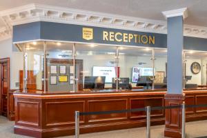 a reception counter in a building with a sign that reads reception at Sachas Hotel Manchester in Manchester
