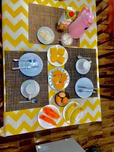 a toy table with plates and fruit on it at Pensão CasaDanilo in Portela +50 photos